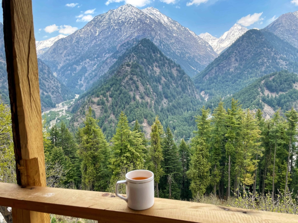 traveller having tea watching the mountains